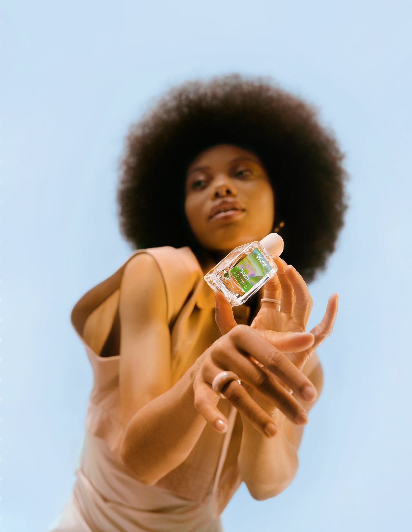 Future Society campaign — model holding the fragrance to the sky