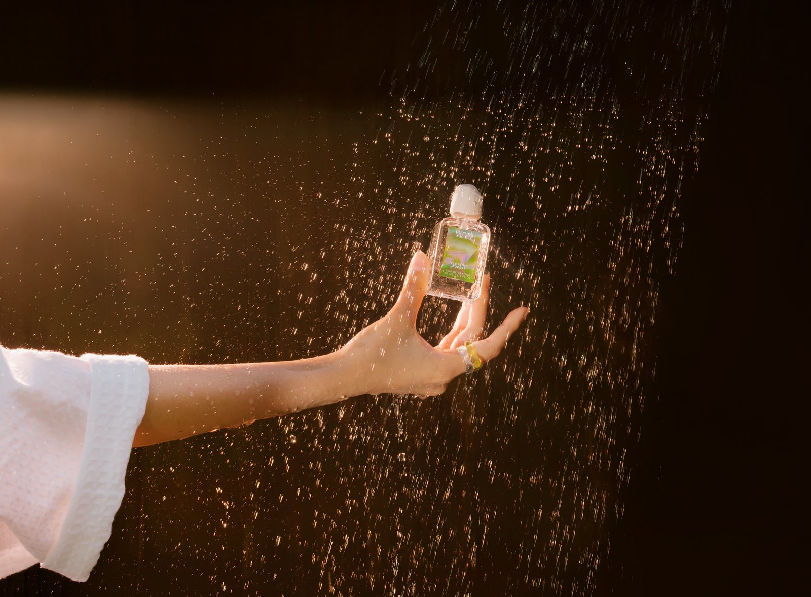 Future Society bottle held in sparkling mist